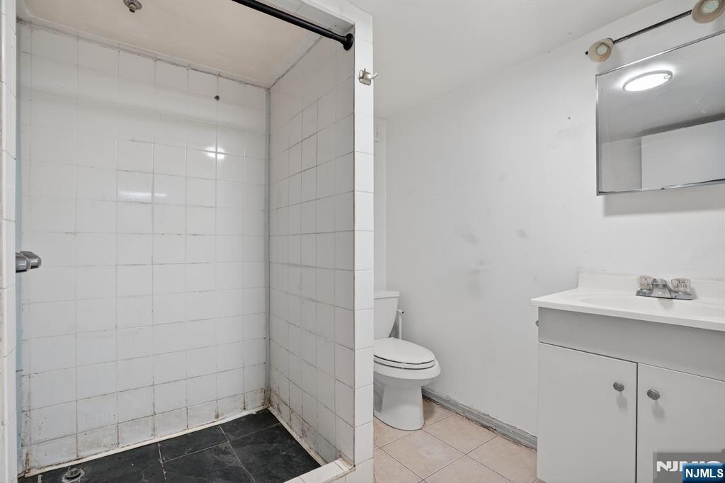 1110 Hampton Place Elizabeth, NJ 07201 - Photo 10 of 23 a bathroom with a toilet sink and shower