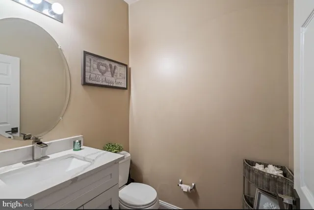 a bathroom with a toilet a sink and mirror