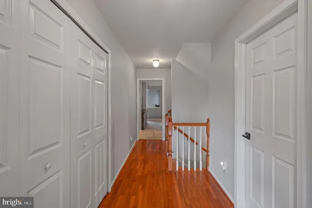 a bathroom with a granite countertop sink toilet and mirror