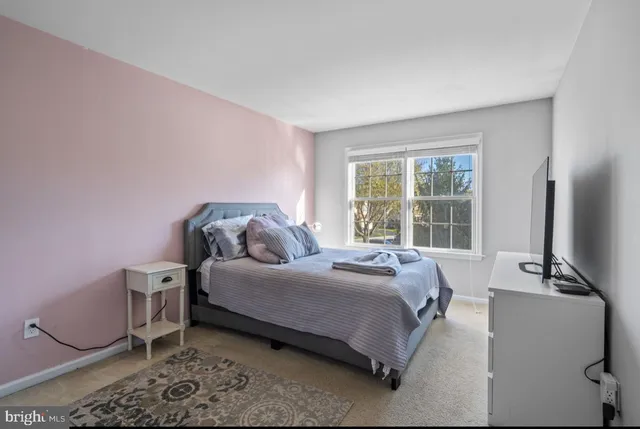 a bedroom with a bed and a night stand