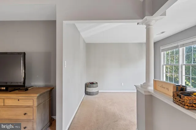 a bedroom with a bed a window and dresser