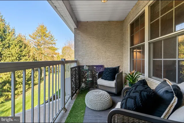 a view of a livingroom with a chair and front door