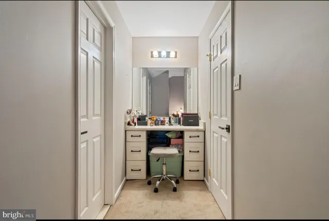 a view of walk in closet with clothes