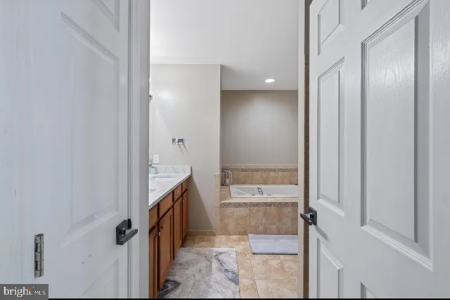 a bathroom with a granite countertop sink mirror and shower