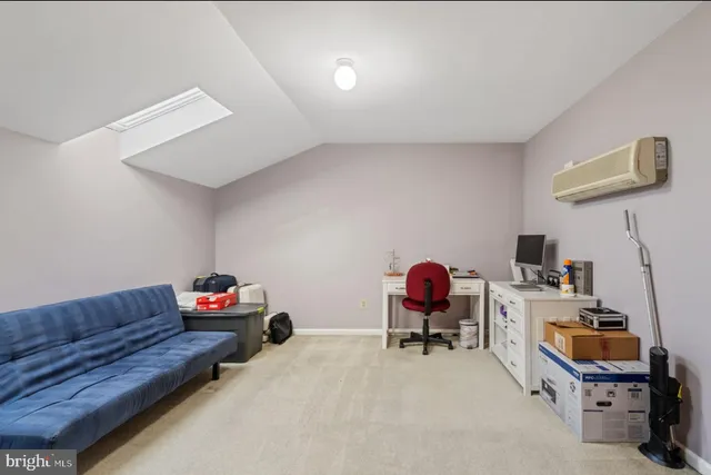 a view of a living room with furniture and wooden floor