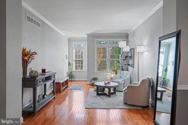 a living room with furniture and wooden floor