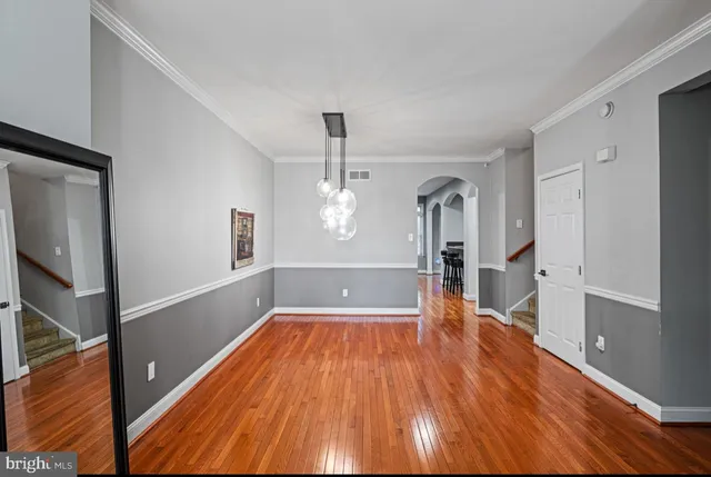 a view of a room with wooden floor and staircase