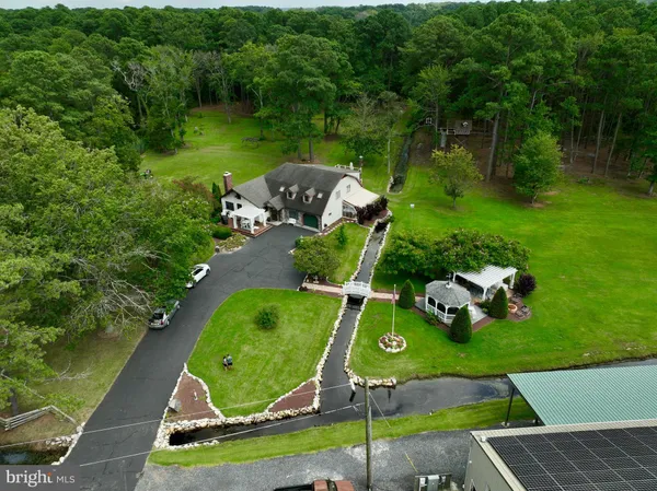 an aerial view of a house with a yard and lake view
