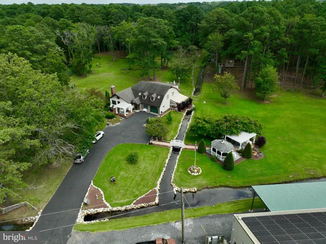 an aerial view of a house with a yard and lake view