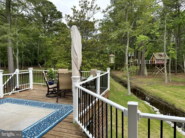 a front view of a house with a yard swimming pool and outdoor seating