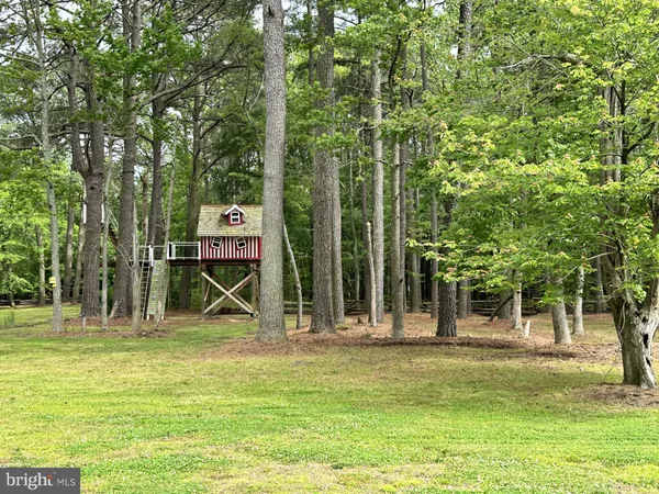 a view of a house with backyard sitting area and garden