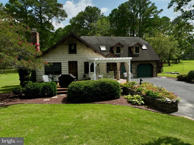 a front view of a house with a yard patio and fire pit