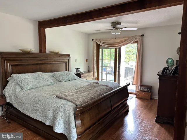 a bathroom with a toilet a sink and a large mirror