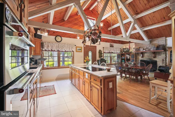 a view of a hallway with wooden floor and windows