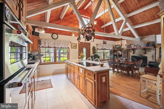 a view of a hallway with wooden floor and windows