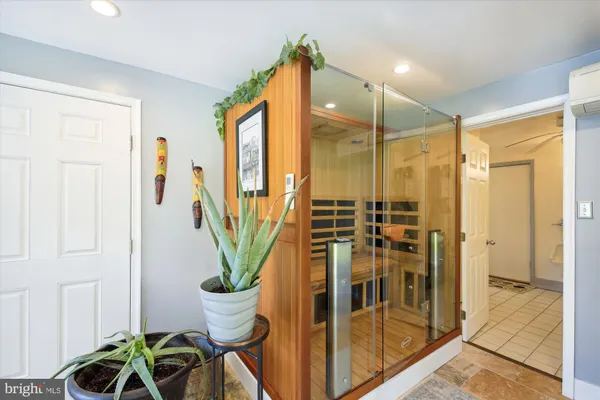 a front view of a house with a yard and potted plants