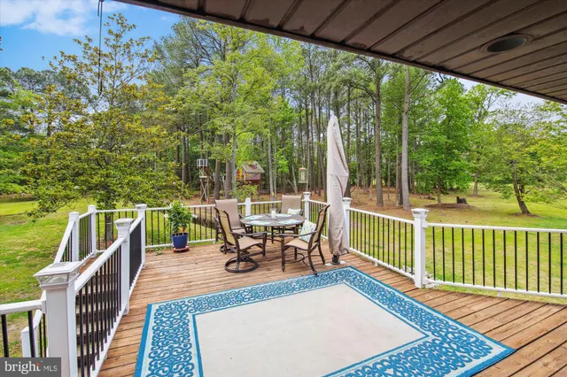 a front view of a house with a garden and trees