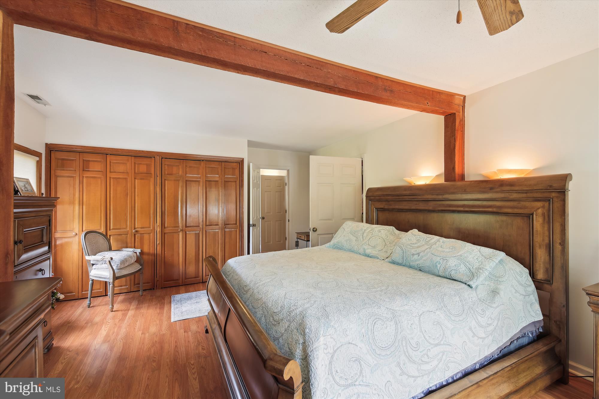 26463 Asbury Avenue Crisfield, MD 21817 - Photo 62 of 94 a bedroom with a bed and wooden floor