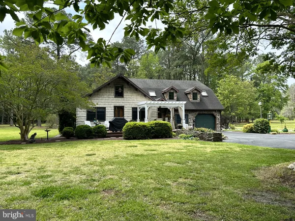 a view of a house with a yard porch and sitting area