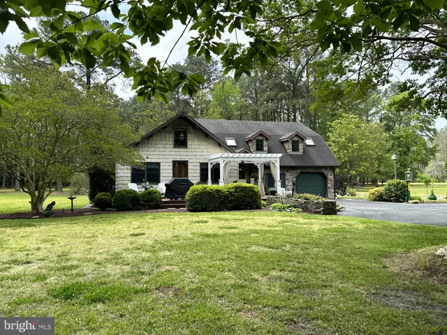 a view of a house with a yard porch and sitting area