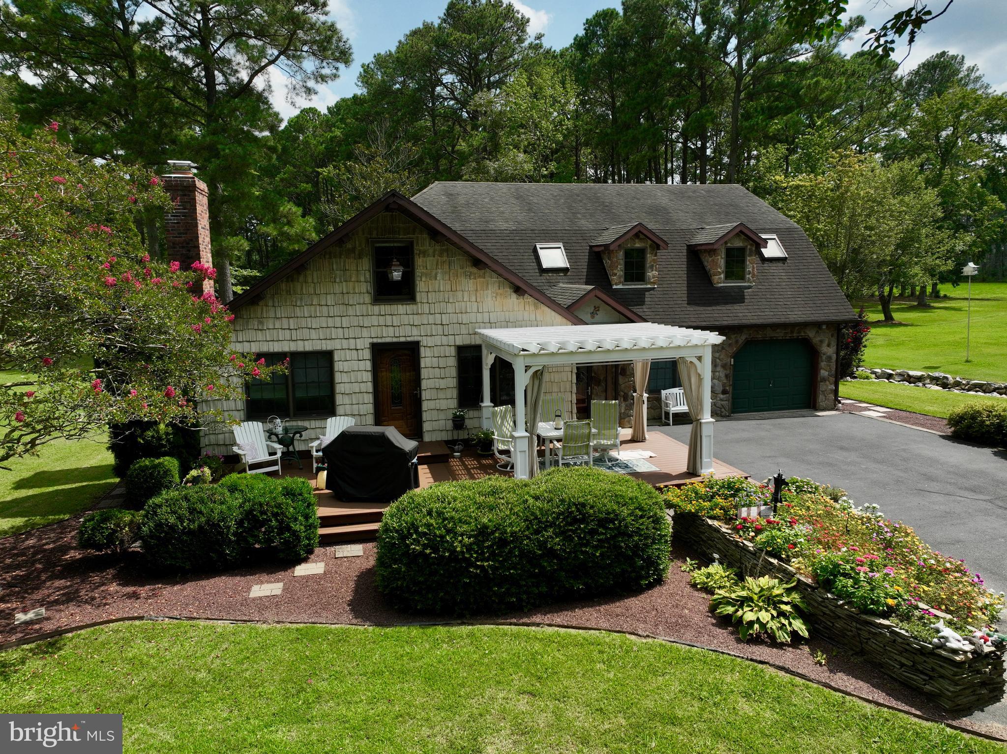 26463 Asbury Avenue Crisfield, MD 21817 - Photo 76 of 94 a front view of a house with a yard and potted plants
