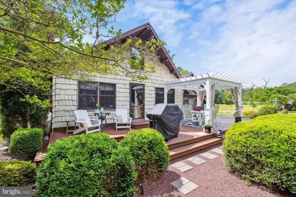 a backyard of a house with lots of trees and entertaining space