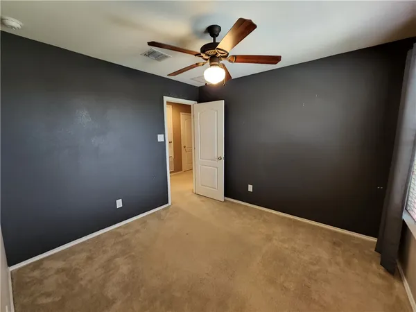 a view of a chandelier fan and a ceiling fan in a room