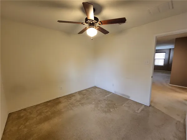 a view of a room with a ceiling fan