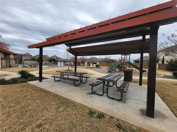 a view of a patio with table and chairs under an umbrella