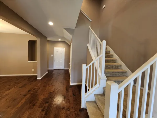 a view of staircase with wooden floor and stairs