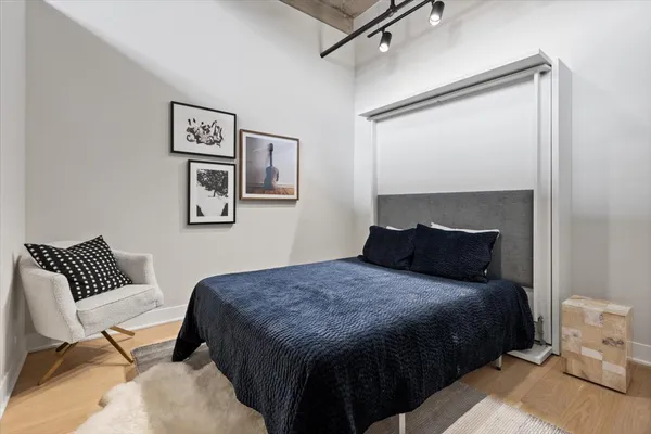 a bedroom with a bed and a chair