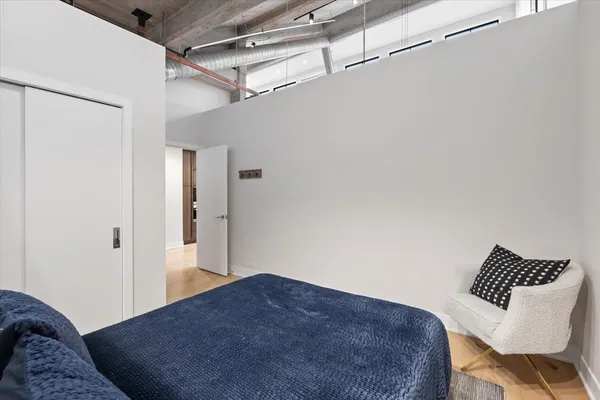 a bedroom with a bed and a chair