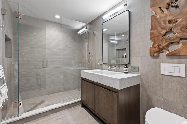 a bathroom with a sink toilet and shower