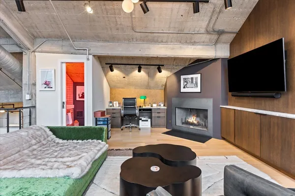 a living room with furniture a flat screen tv and a fireplace