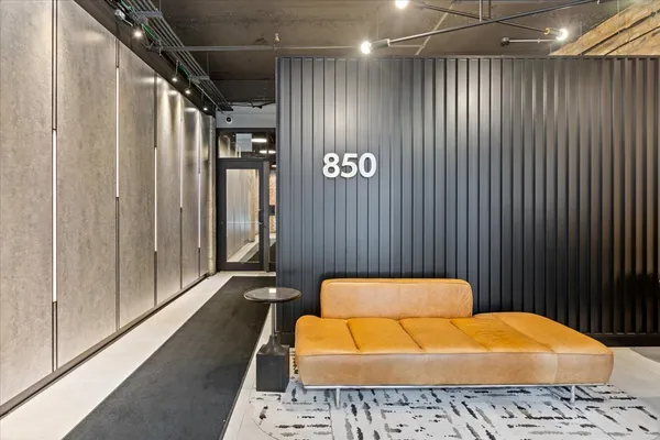 a hallway with a couch and a rug