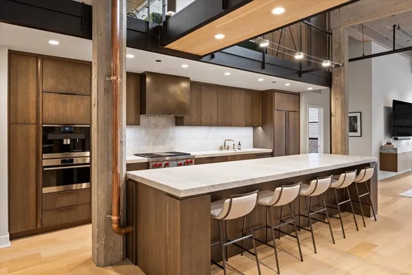 a kitchen with a table chairs refrigerator and microwave