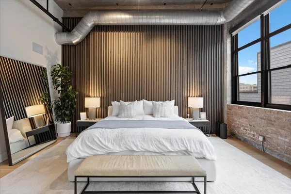 a bedroom with a bed and a mirror