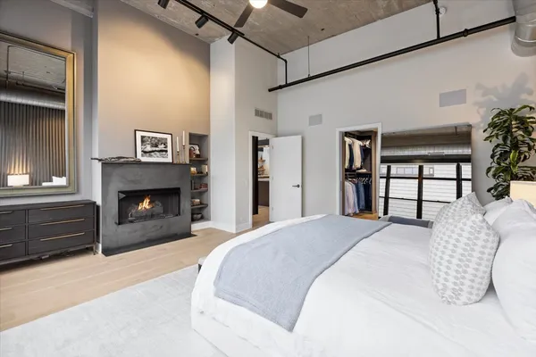 a spacious bedroom with a bed and a fireplace