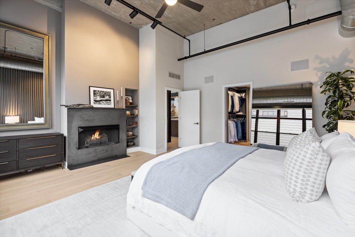 850 West Adams Street, Unit 7E Chicago, IL 60607 - Photo 10 of 27 a spacious bedroom with a bed and a fireplace