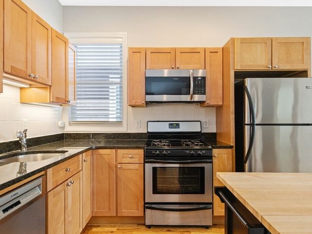 a kitchen with a sink stove and microwave