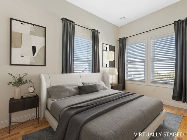 a bedroom with a large bed and a window