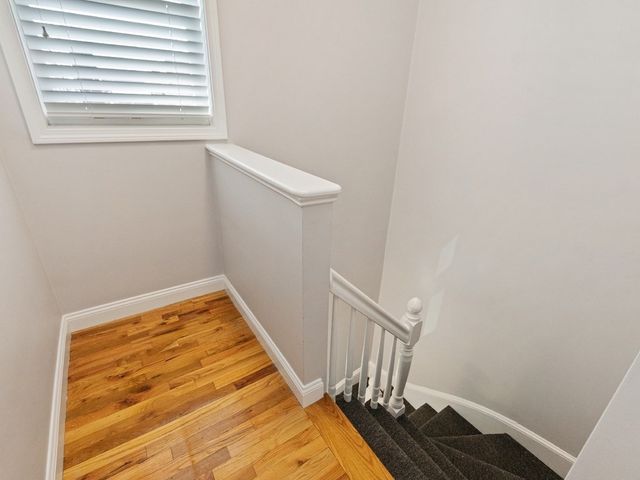 a view of a room with wooden floor and a window
