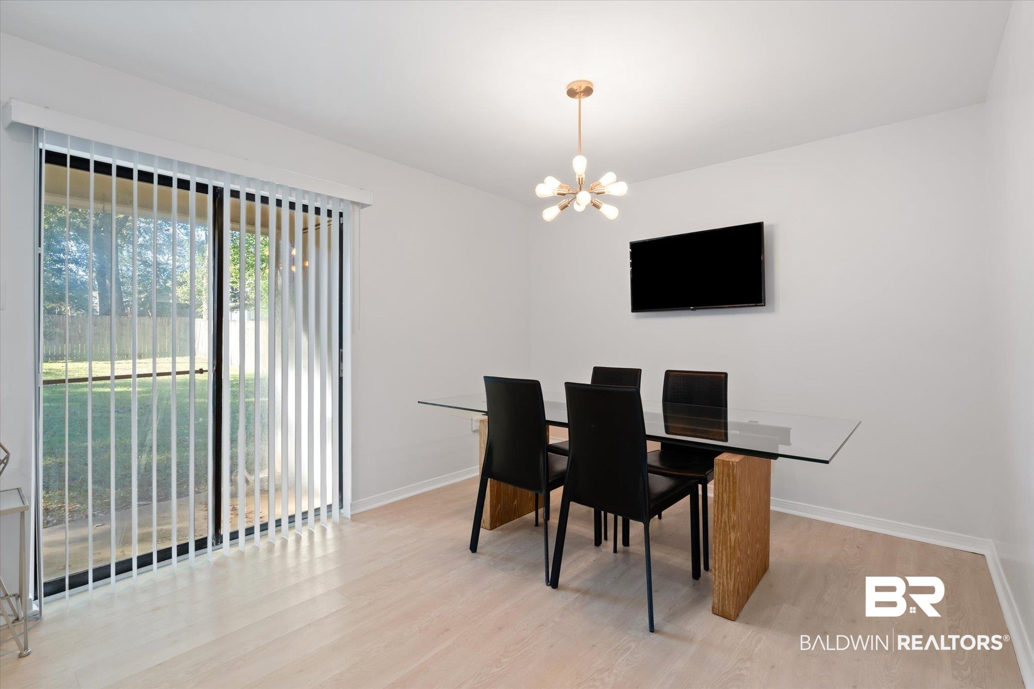 1008 Mcneil Avenue Mobile, AL 36609 - Photo 5 of 20 Dining area with light wood-type flooring and a notable chandelier