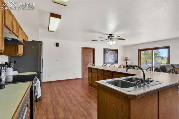 a kitchen with a sink appliances and a living room