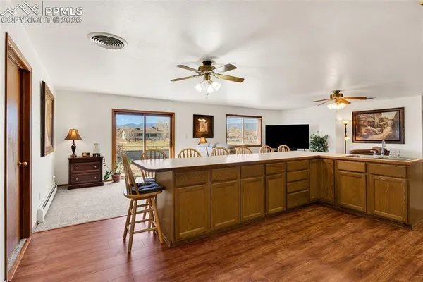 a kitchen with a sink dining table and chairs