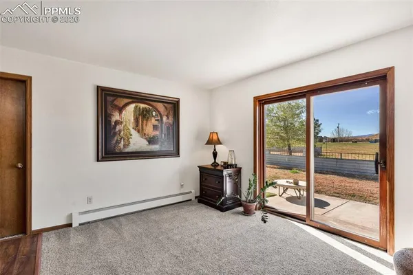a living room with furniture a flat screen tv and a window
