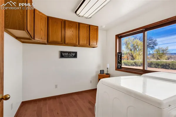 a room with wooden floor and window