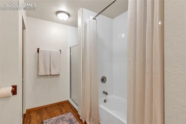 a bathroom with a bathtub and a shower