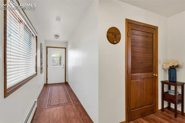 a view of hallway with wooden floor
