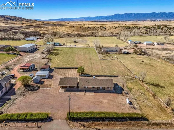an aerial view of residential houses with outdoor space